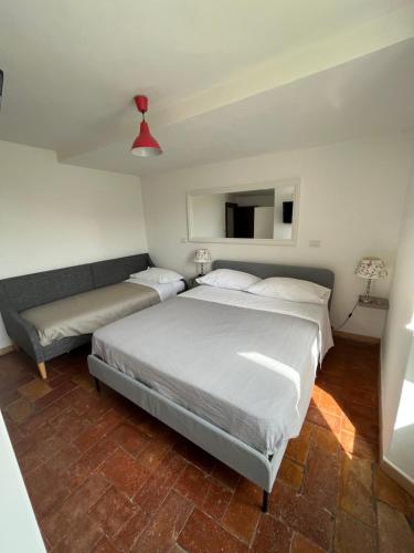 a bedroom with a large bed and a couch at La Bracceschina in Spoleto