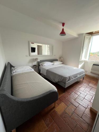 een slaapkamer met 2 bedden en een bank. bij La Bracceschina in Spoleto