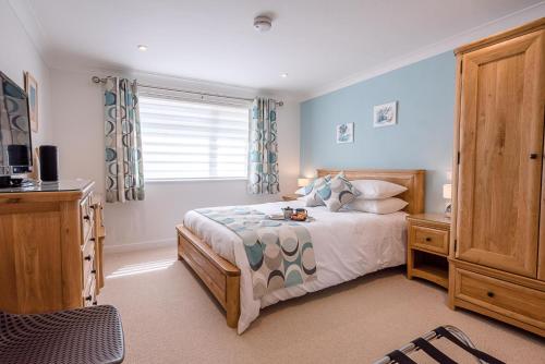 a bedroom with a bed and a window at Hattie's in Saxmundham