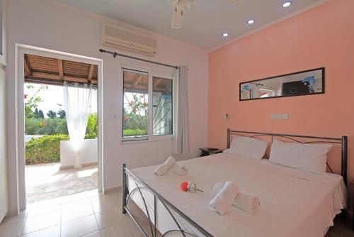 a bedroom with a large bed with towels on it at Andromaches sea view studio in Achílleion