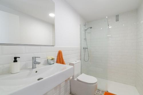 ein Bad mit einem WC, einem Waschbecken und einer Dusche in der Unterkunft MalagaSuite Living Coast Fuengirola in Fuengirola
