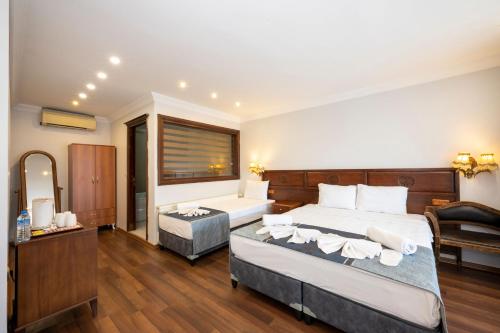 a bedroom with a large bed and a desk at Valdivia Hotel Sultanahmet in Istanbul