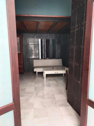a living room with a bench and a table at Hostal Palacio San Bartolomé in El Puerto de Santa María