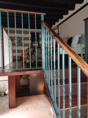 a staircase in a house with a couch under it at Hostal Palacio San Bartolomé in El Puerto de Santa María