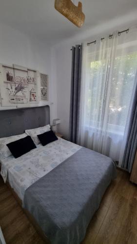 a bedroom with a large bed and a window at Park Residence in Bacău
