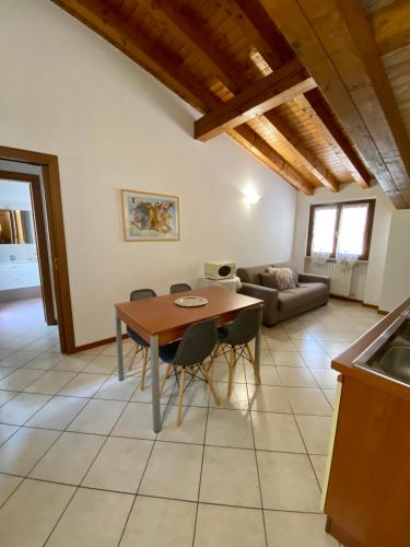 a kitchen and living room with a table and chairs at Residence la Lucciola in Lonato del Garda