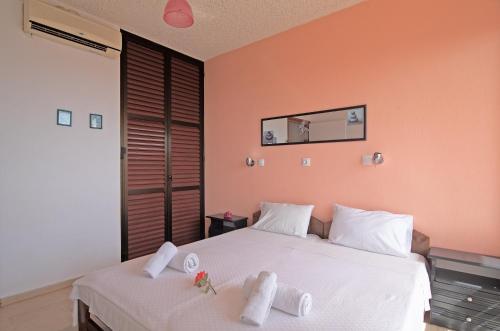 a bedroom with two beds with towels on them at Andromaches sea view studio 2 in Achílleion