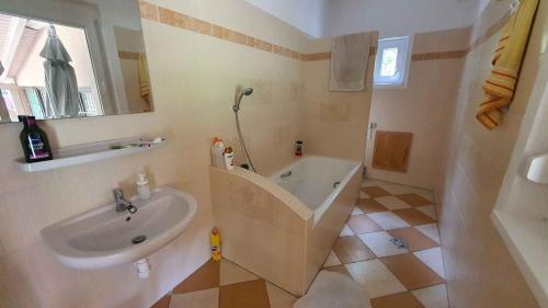 a bathroom with a sink and a bath tub at Holiday home Balatonlelle - Balaton 19095 in Balatonlelle