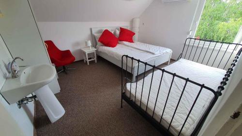 a small bedroom with a bed and a sink and a mirror at Holiday home Balatonlelle - Balaton 19095 in Balatonlelle