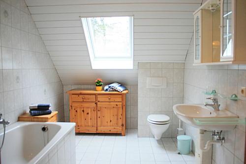 a bathroom with a sink toilet and a window at Ferienwohnung Anna in Wermelskirchen