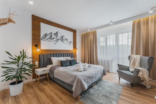 a bedroom with a bed and a chair at Pod Horodkiem in Cisna