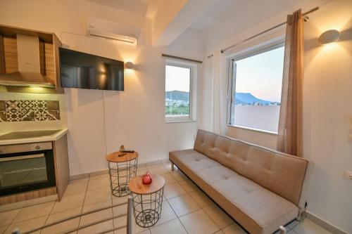 a living room with a couch and a window at Artemis No.2 Apartment in Kissamos