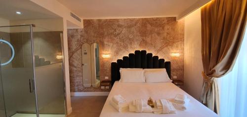 a bedroom with a bed and a glass shower at I Tre Re in Bardolino