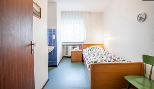 a small bedroom with a bed and a sink at Hotel Schwung in Bocholt
