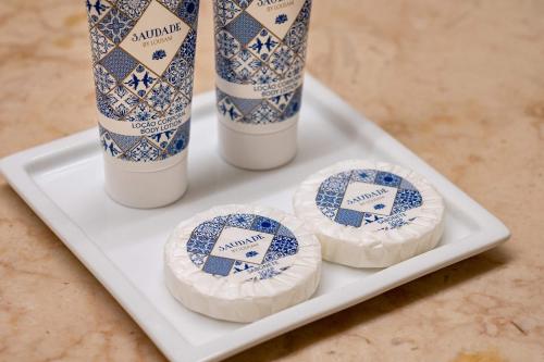 a white plate with two blue and white vases on it at Hotel do Chiado in Lisbon