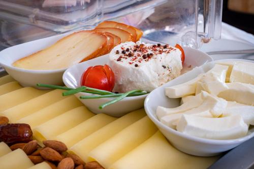 a tray of food with cheese and other foods at Hotel do Chiado in Lisbon
