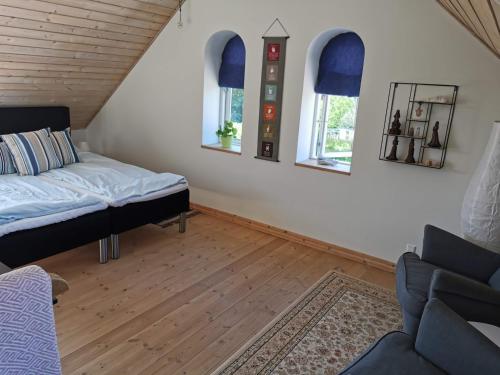 a small room with a bed and a couch at Safine B&B in Fåborg