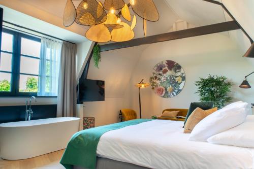 a bedroom with a bed and a bath tub at Hotel van der Meer in Dokkum