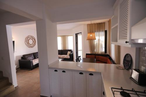 a kitchen and a living room with a counter top at Monta Verde Hotel & Villas in Oludeniz