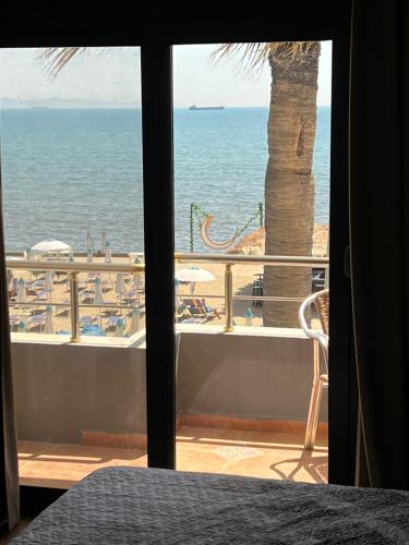 a view of the ocean from a bedroom window at Hotel Zen in Durrës