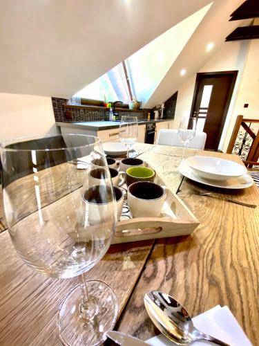 a wooden table with wine glasses on top of it at Chalupa MATEJKO in Liptovský Mikuláš