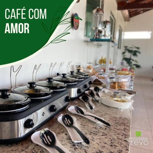 a kitchen with a counter with a stove and spoons at Hotel Trevo Caruaru in Caruaru