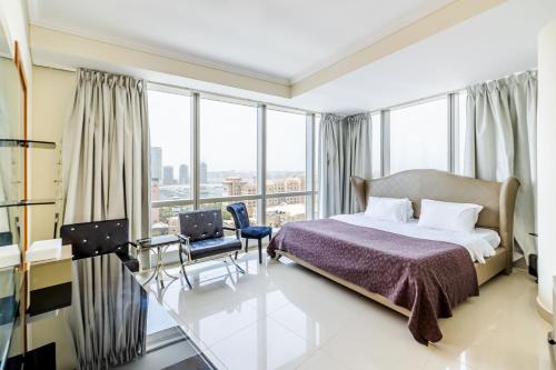 a hotel room with a bed and a large window at Large 3BR With City View in Dubai Marina Ocean Heights - DHH in Dubai