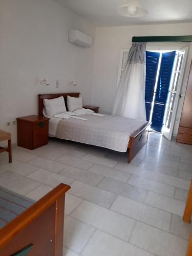 a bedroom with a bed and a window at Galanos Studios in Naxos Chora