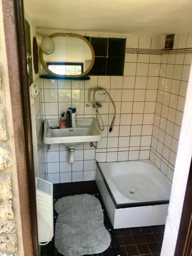 a small bathroom with a sink and a tub at Chata Prístav in Námestovo