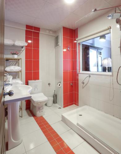 a bathroom with a tub and a toilet and a sink at URLA PERA HOTEL in Urla