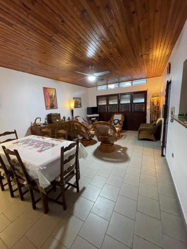 a dining room with a table and a living room at CD House in Fort-de-France