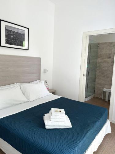 a hotel room with a bed with a towel on it at Hotel Riva e Mare in Rimini