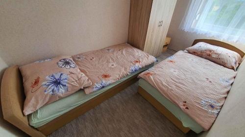 two twin beds in a room with a window at Holiday home in Balatonlelle 38068 in Balatonlelle