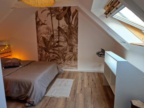 a bedroom with a bed and a mural on the wall at Logement de caractère en haute ville de Quimperlé in Quimperlé
