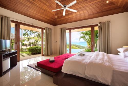 a bedroom with a large bed and a large window at Ban Reemo Luxury Villa in Bophut 
