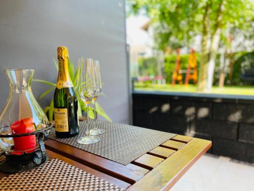 two bottles of champagne sitting on a table with glasses at Ferienwohnung in Stockach am Bodensee in Stockach