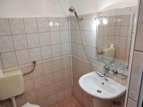 a bathroom with a sink and a mirror at Zlatevi Guest House in Obzor
