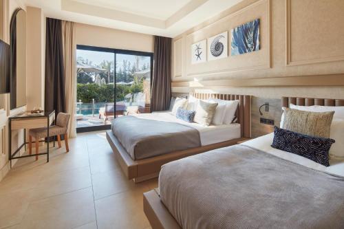 a hotel room with two beds and a balcony at Liu Resorts in Side