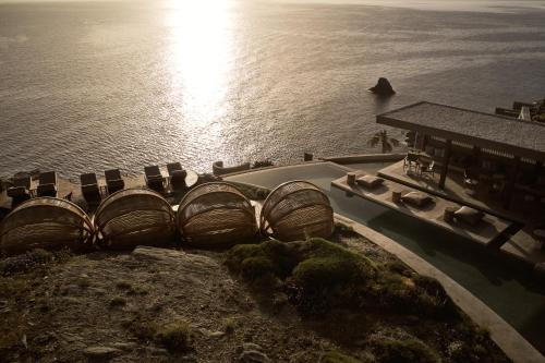 an aerial view of the ocean and a building at Acro Suites - A Wellbeing Resort in Agia Pelagia