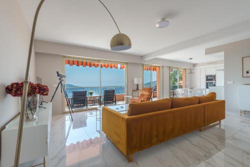 a living room with a couch and a table at Villefranche Bay View in Villefranche-sur-Mer