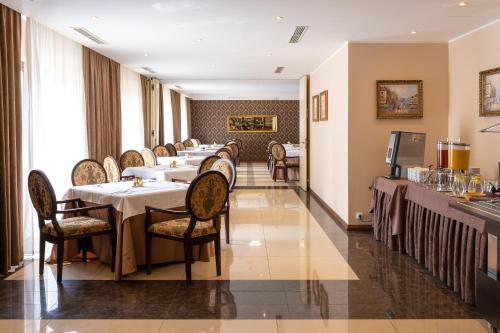 a long dining room with tables and chairs at Spa Hotel Vita in České Budějovice