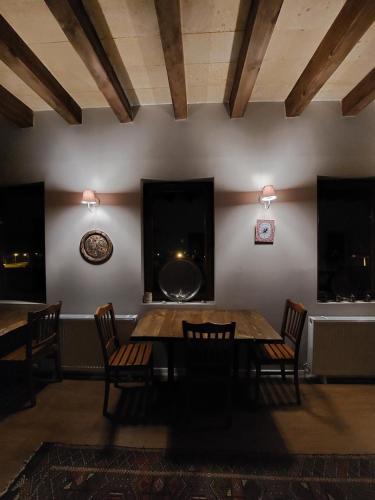 a dining room with a table and chairs at Grand Uchisar Hotel in Uchisar