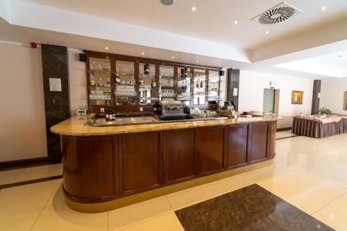 a bar in a hotel lobby with a counter at Spa Hotel Vita in České Budějovice