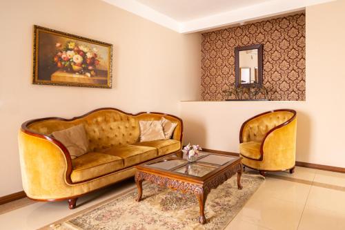 a living room with two couches and a coffee table at Spa Hotel Vita in České Budějovice
