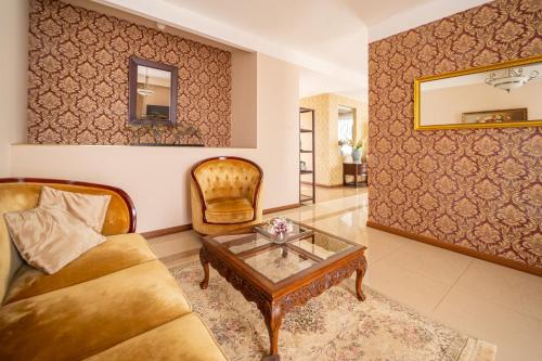 a living room with a couch and a coffee table at Spa Hotel Vita in České Budějovice