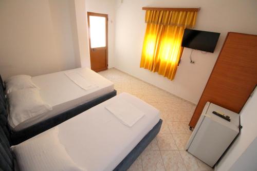 Ένα ή περισσότερα κρεβάτια σε δωμάτιο στο Hotel Vila Vilson