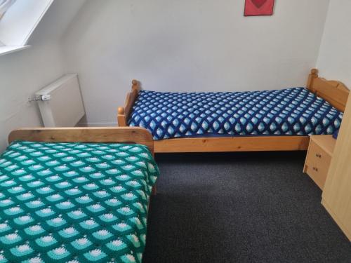 two beds sitting next to each other in a room at Hotel Schwung in Bocholt