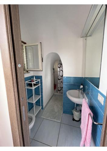 a blue and white bathroom with a sink and a toilet at Amalfi Coast Casa Ida in Vietri sul Mare