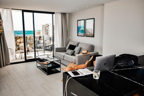 a living room with a couch and a laptop at HO Aguadulce By Olivencia in Aguadulce