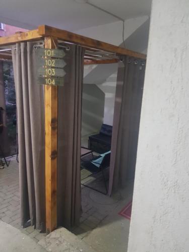 a reflection of a room with a sign on a wall at Malda's Apartment in Pristina